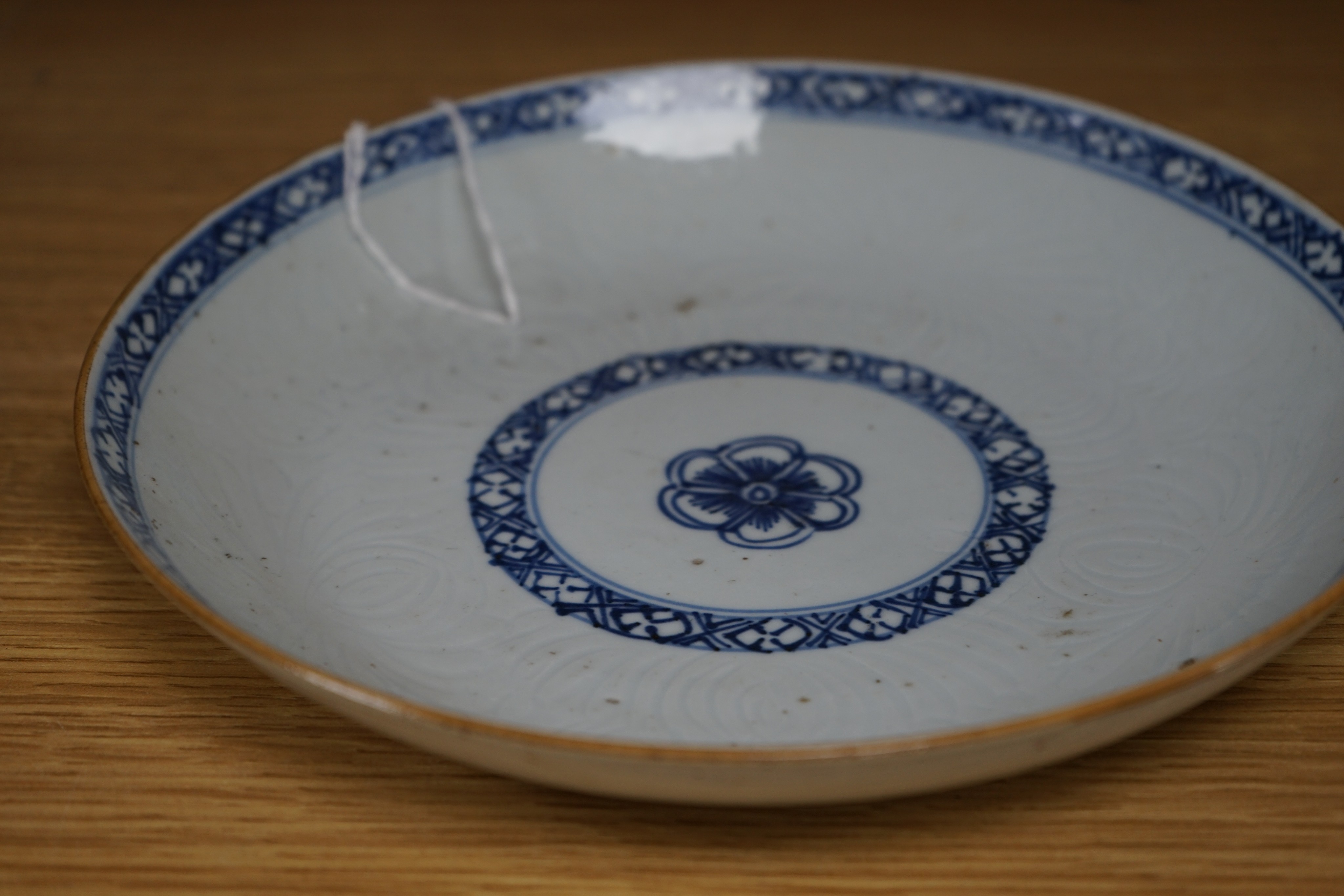 An 18th century Chinese shallow circular blue and white dish with incised decoration, Dia 22cm